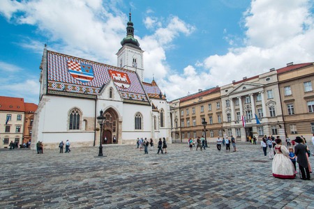 48748996 - zagreb, croatia, may 31th 2015: st mark's square in zagreb, croatia, surrounded by tourists. st mark's square is political center of croatia and popular tourist location.