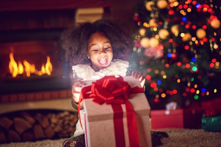66857433 - surprise girl opening christmas magic presents
